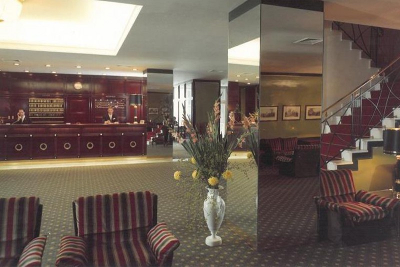 Aged photograph showing the old reception of the hotel, capturing the vintage charm and classic design.
